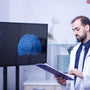 Doctor examining brain scan on monitor