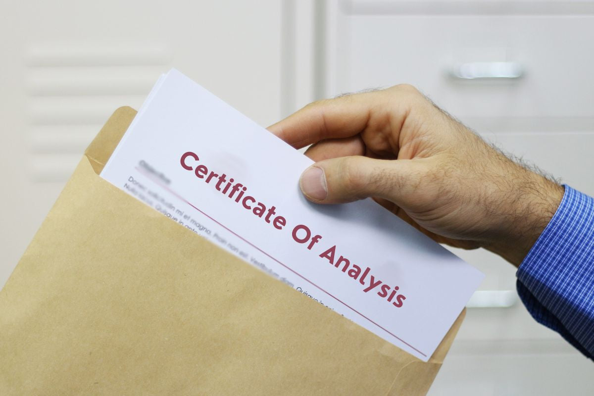 Man holding Certificate of Analysis document