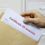 Man holding Certificate of Analysis document