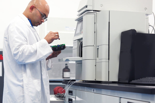 Researcher analyzing Tianeptine samples using laboratory equipment.