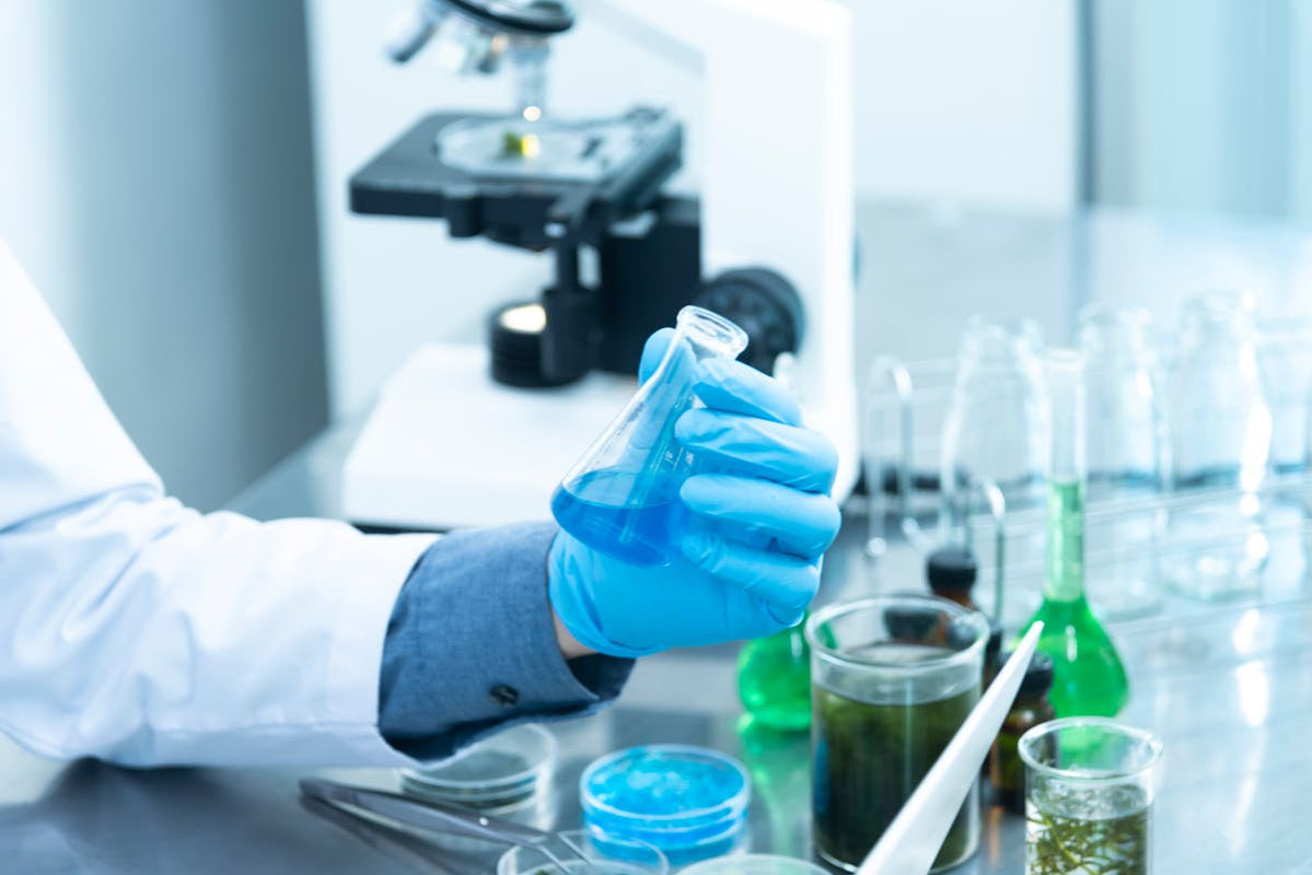 Researcher holding laboratory flask