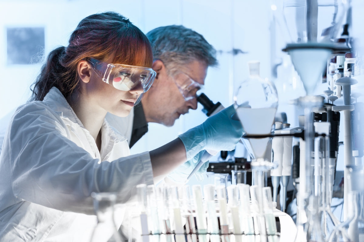 Two scientists documenting findings from Phenibut research.