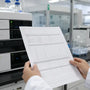 Researcher reviewing pramiracetam certificate of analysis in laboratory 