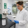 Researcher reviewing Pramiracetam safety data sheet at laboratory bench with first-aid equipment 