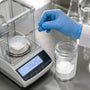 White powder transfer on analytical balance in lab
