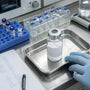 Research compound vial on stainless steel laboratory tray
