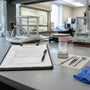Phenibut research use SOP on a clipboard beside a sealed powder container and laboratory equipment
