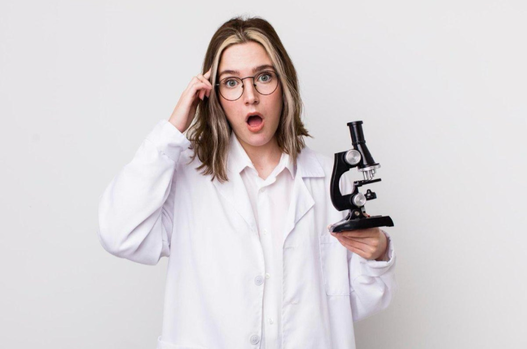 a researcher holding a microscope