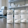 Clear laboratory vials of white crystalline pramiracetam research material