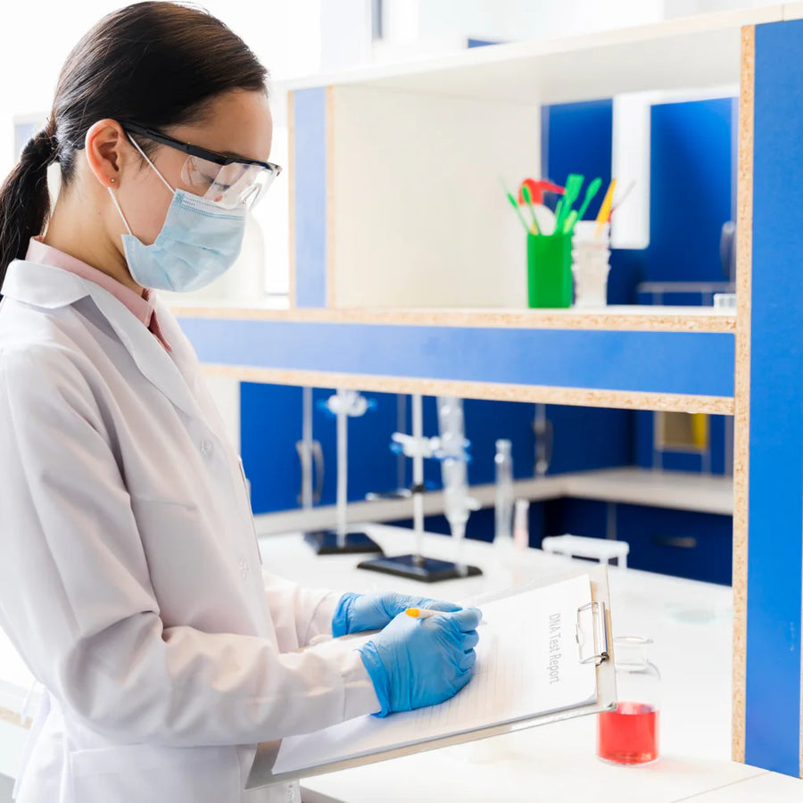 Researcher writing notes on a clipboard in a laboratory