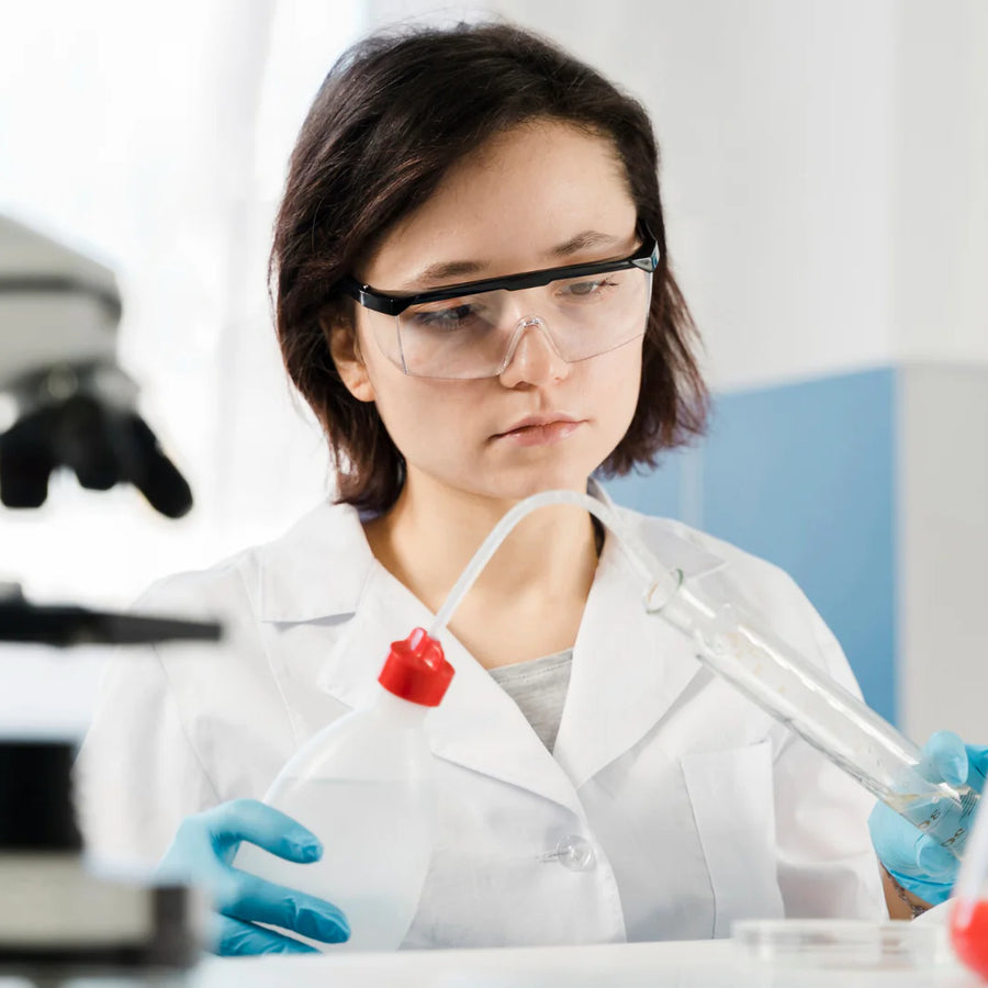 Young woman researcher with protection glasses