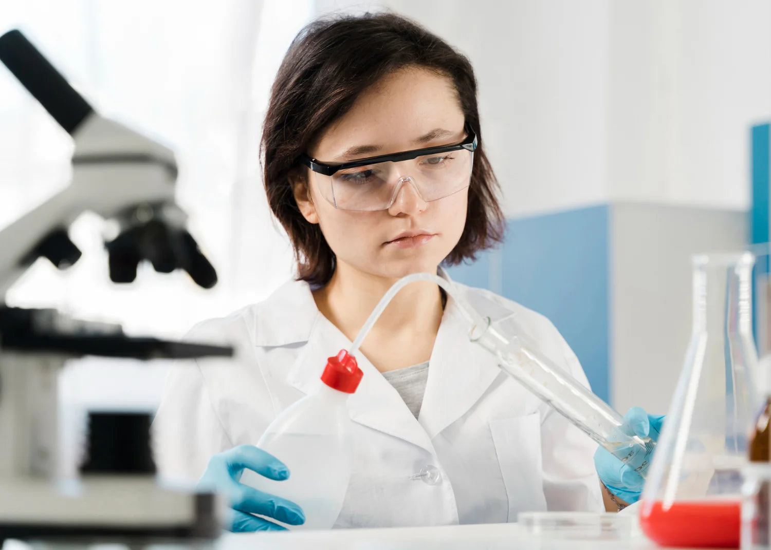 Young woman researcher with protection glasses