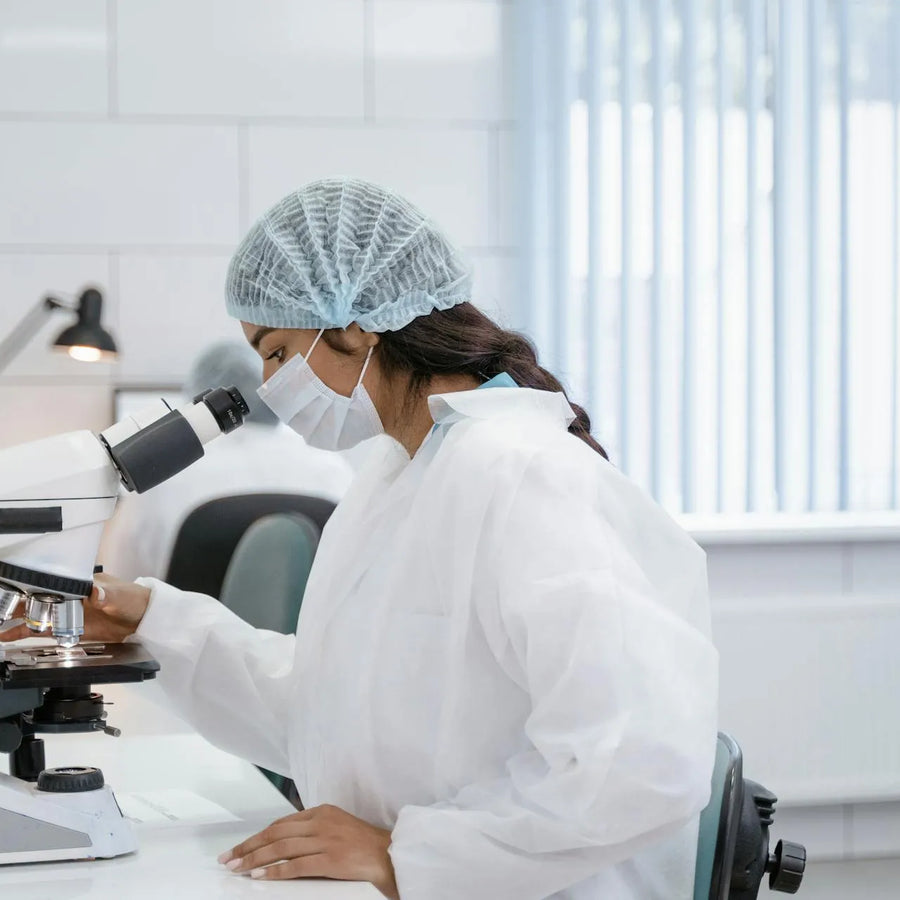 a woman with complete ppe conducting a research