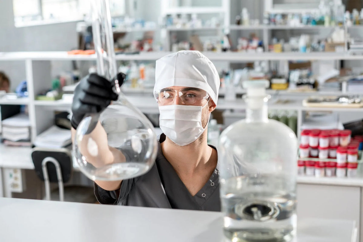 a man in laboratory setting holding lab equipment