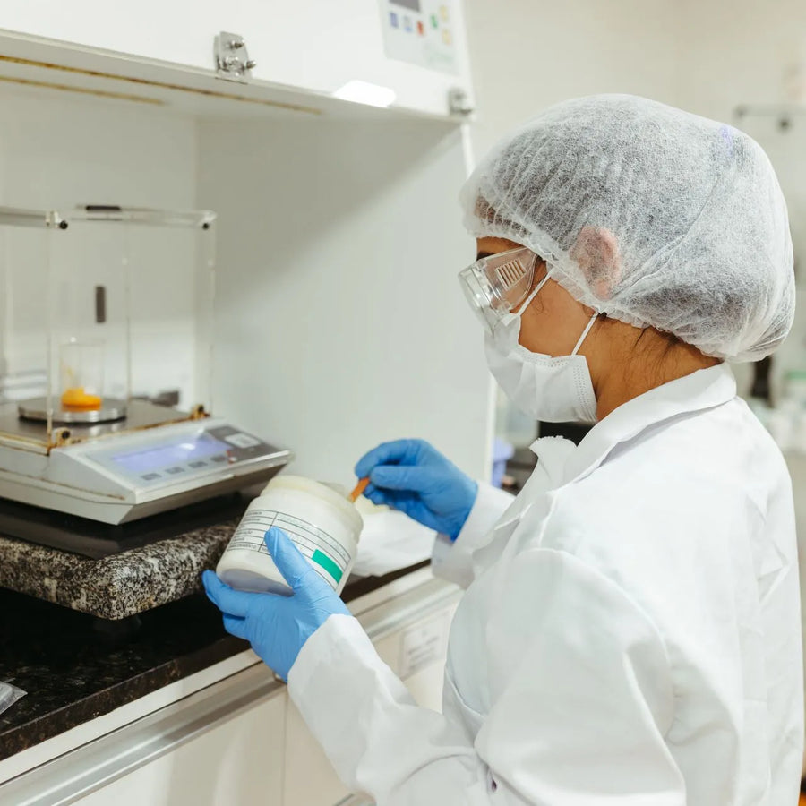 a woman conducting lab research on phenibut powder