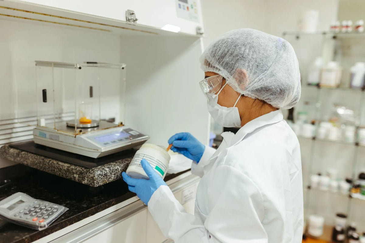 a woman conducting lab research on phenibut powder