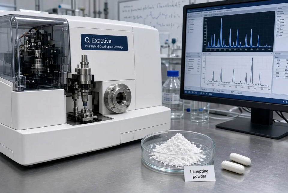 Q Exactive hybrid quadrupole-Orbitrap mass spectrometer on a lab bench next to a glass dish of white powder labeled tianeptine powder and two solid white capsules; a spectrum is visible on the computer monitor.